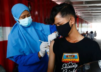 Um jovem recebe a vacina Coronavac, produzida pela empresa chinesa Sinovac, em Jacarta, Indonésia (Foto: Ajeng Dinar Ulfiana/Reuters)